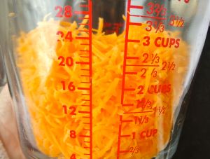 Hand grating will give you about 3 cups of finely grated cheddar. 