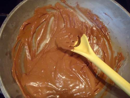 The layer of chocolate acts like a barrier to the rum cream and fruit so the crust stays "crustier" longer. Plus chocolate goes together so well with fruit like berries...