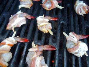 Place the bacon wrapped shrimp on the hot grill and rush with the glaze.