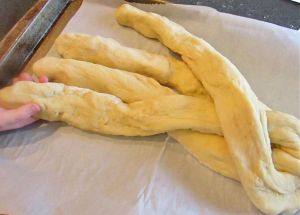 Begin braiding the bread according to the instructions below.