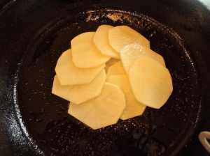 Start the first layer in the middle of the pan. Overlap the potatoes some. I use my "best" slices for the first layer - which will be the top.