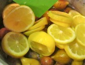 Remove the green stems from the figs and wash them off before tossing -gently -into the pot with the lemons, water and sugar.